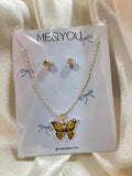 Butterfly necklace and earrings set on a 'ME&YOU' branded card.